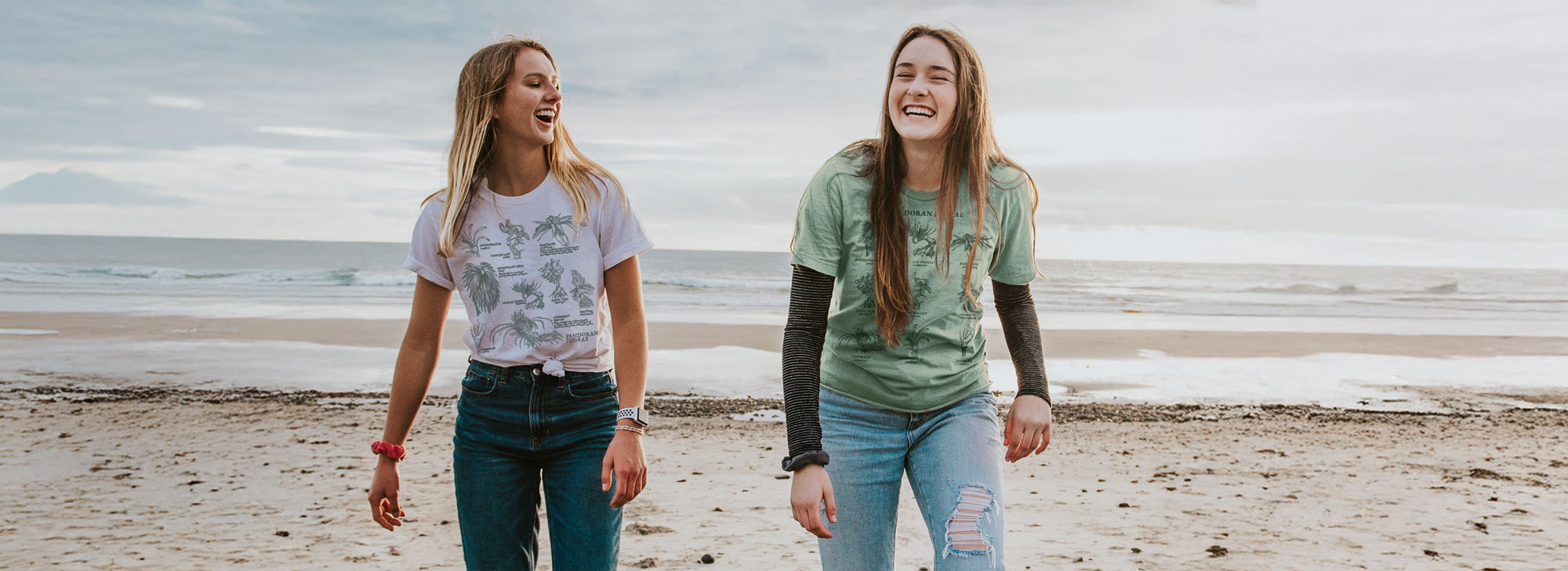 Two girls laughing on the beach